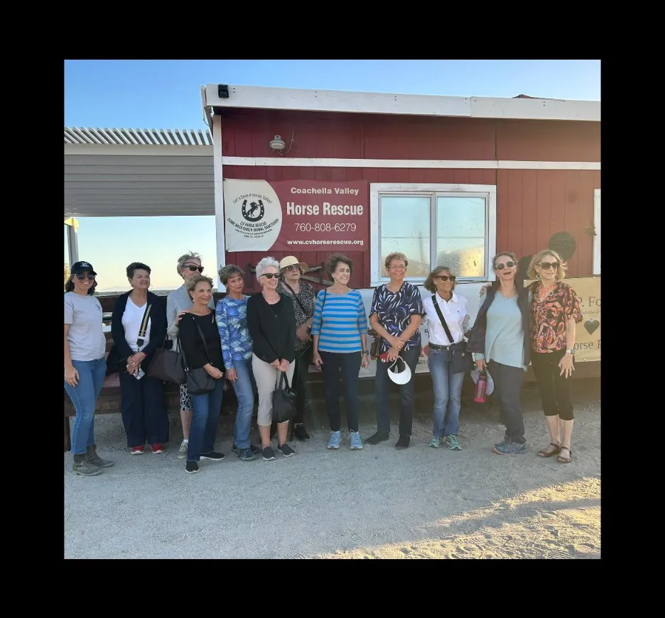 A group of community members touring the Coachella Valley Horse Rescue barn