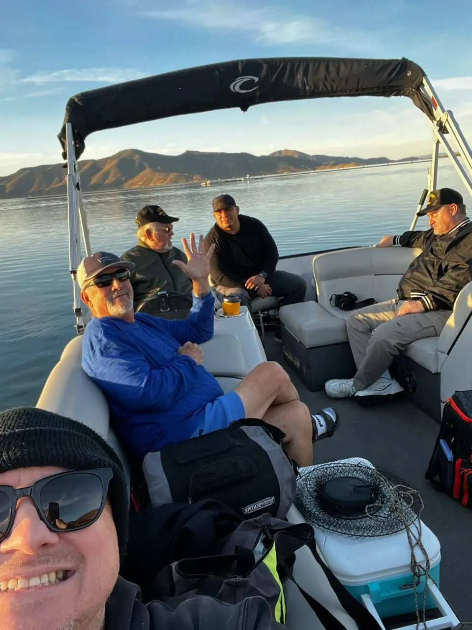 A group of veterans relaxing together on a fishing boat during a bonding retreat