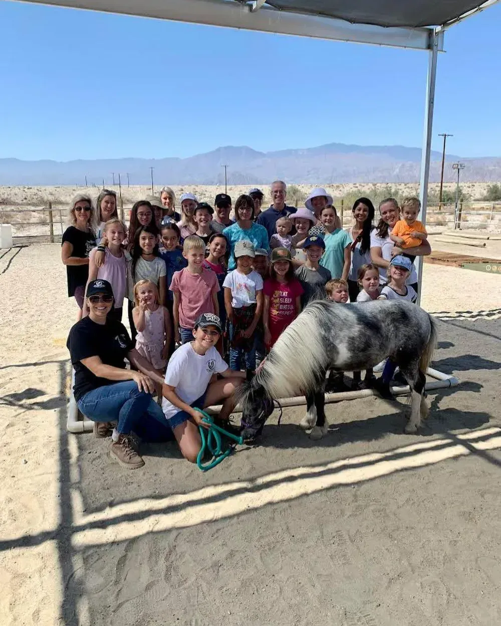 Kids Camp group photo with a pinto miniature horse at Coachella Valley Horse Rescue